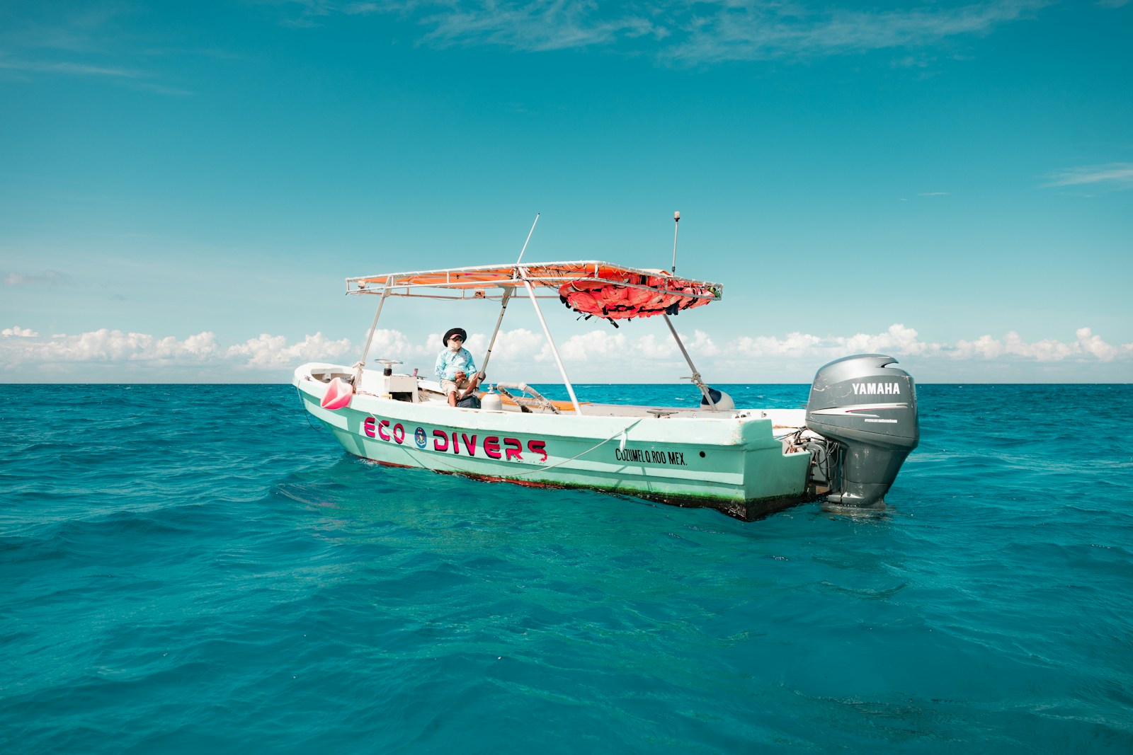 A dive boat floats in beautiful blue waters.